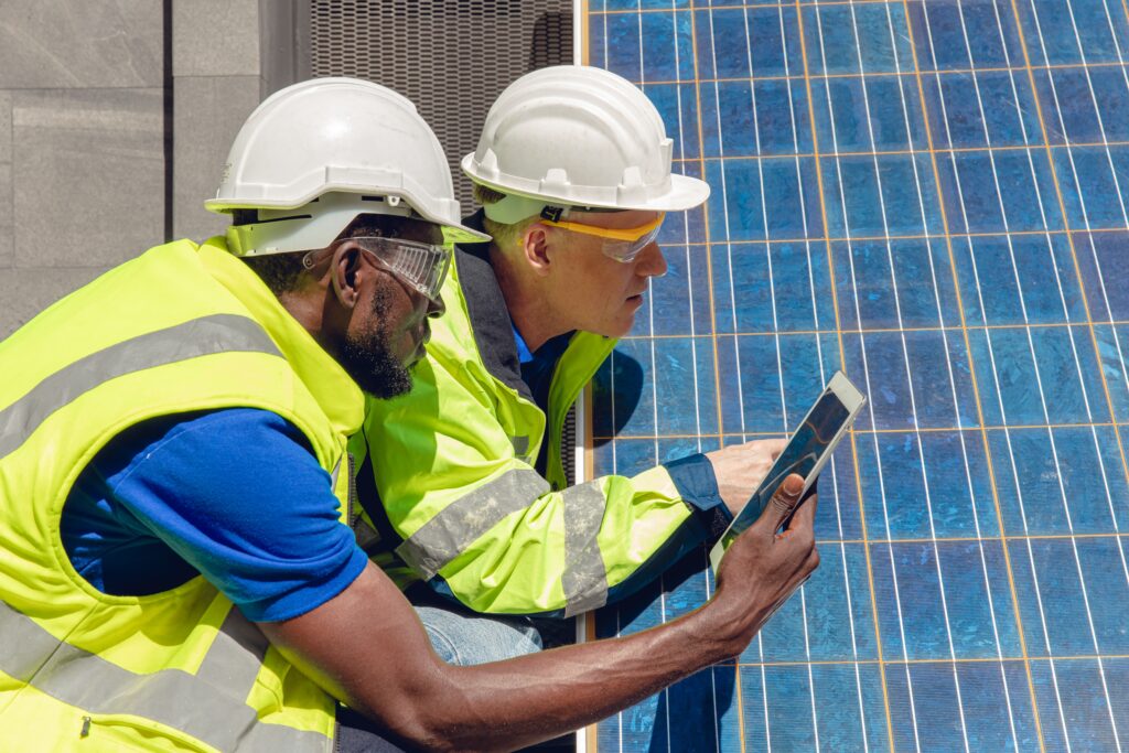 Technicians maintenance solar panel and checking cell working with tablet for home alternative renewable green energy concept