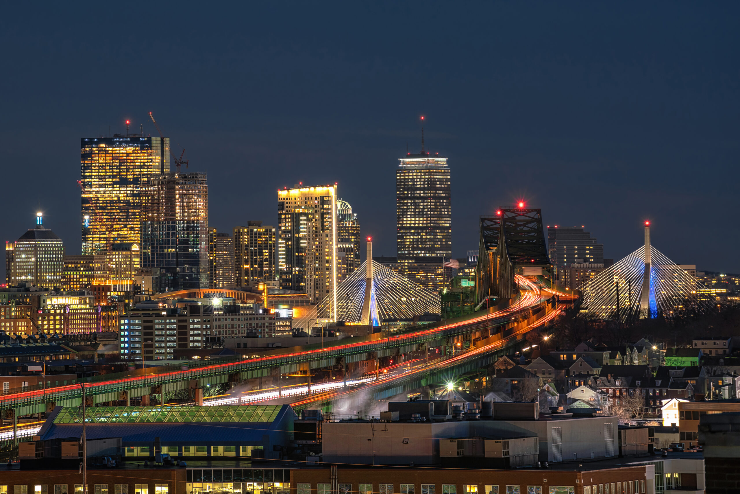 Scene of Boston skyline which can see Zakim Bridge and Tobin Bridge with express way over the Boston Cityscape at twilight time, USA downtown skyline, Architecture and building with tourist concept